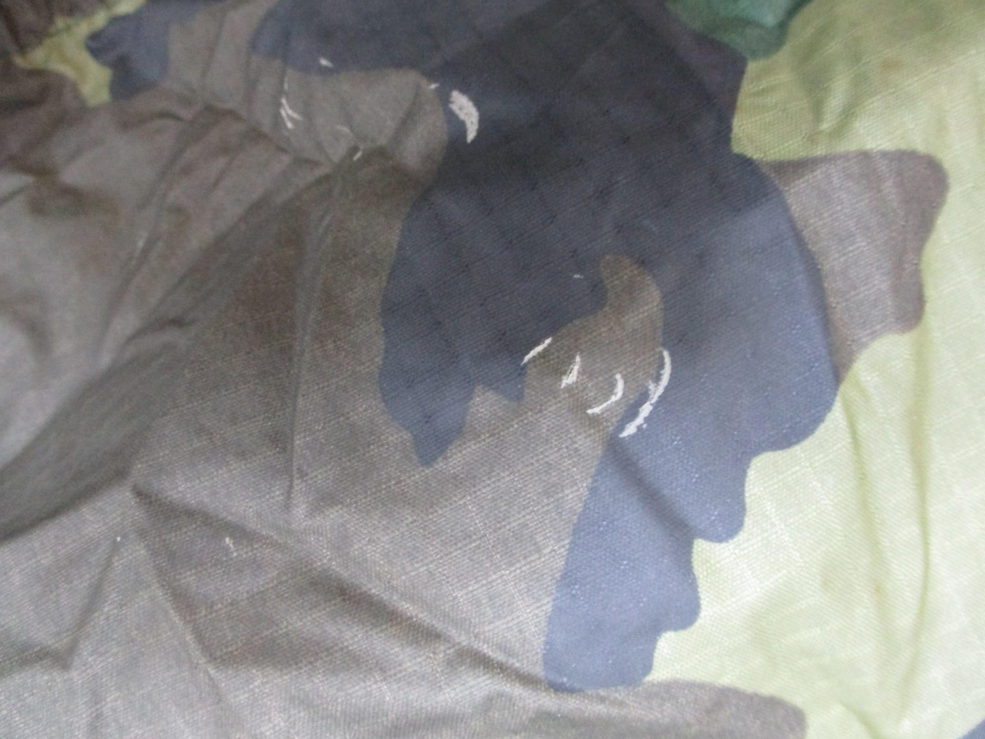 USGI military rain poncho in woodland camouflage, made of ripstop fabric, by Centex Military Gear, designed for outdoor protection