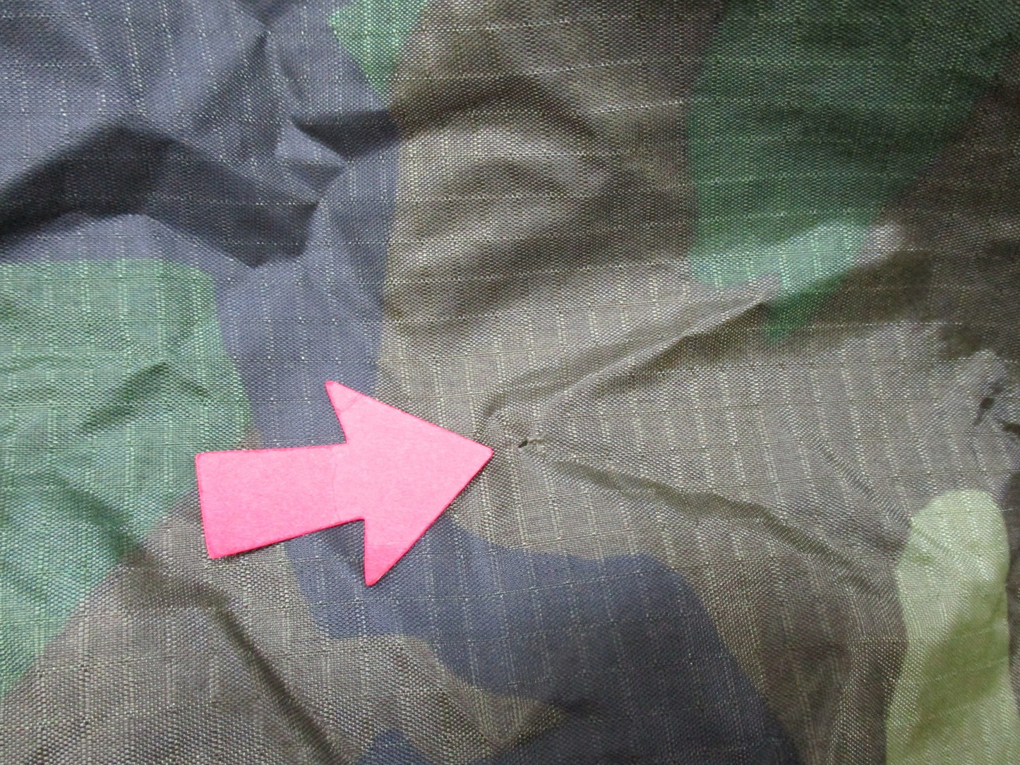 USGI military rain poncho in woodland camouflage, made of ripstop fabric, by Centex Military Gear, designed for outdoor protection.