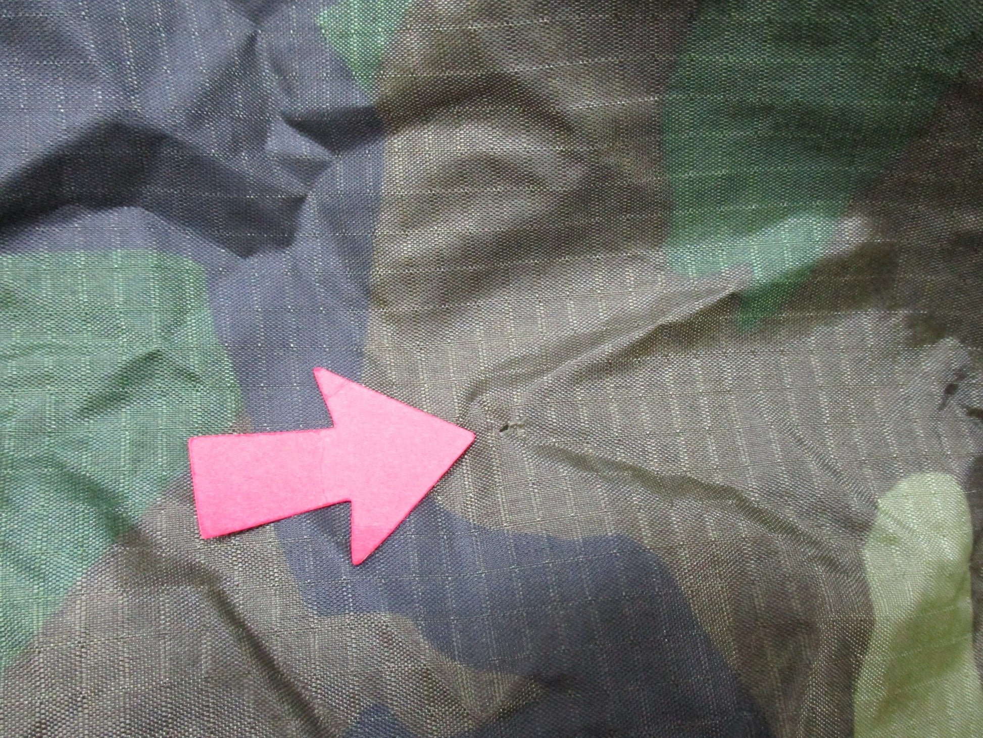 USGI military rain poncho in woodland camouflage, made of ripstop fabric, by Centex Military Gear, designed for outdoor protection.