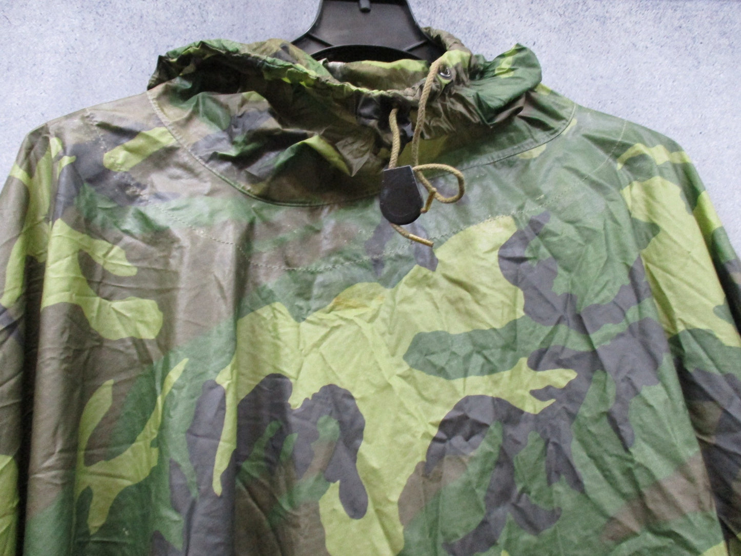 USGI military rain poncho in woodland camouflage, ripstop fabric, durable waterproof design by Centex Military Gear.
