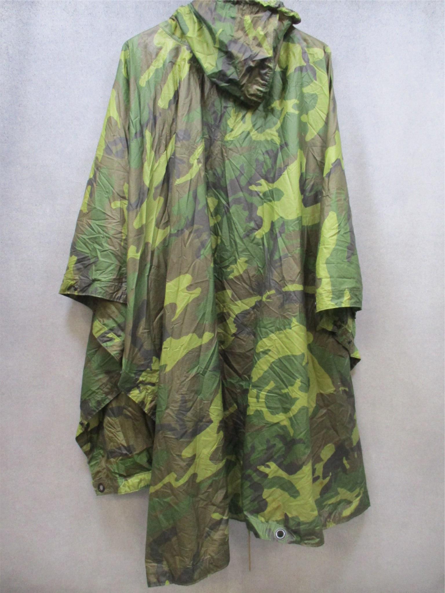 USGI military rain poncho in woodland camouflage, ripstop fabric, designed for outdoor survival and tactical use by Centex Military Gear.