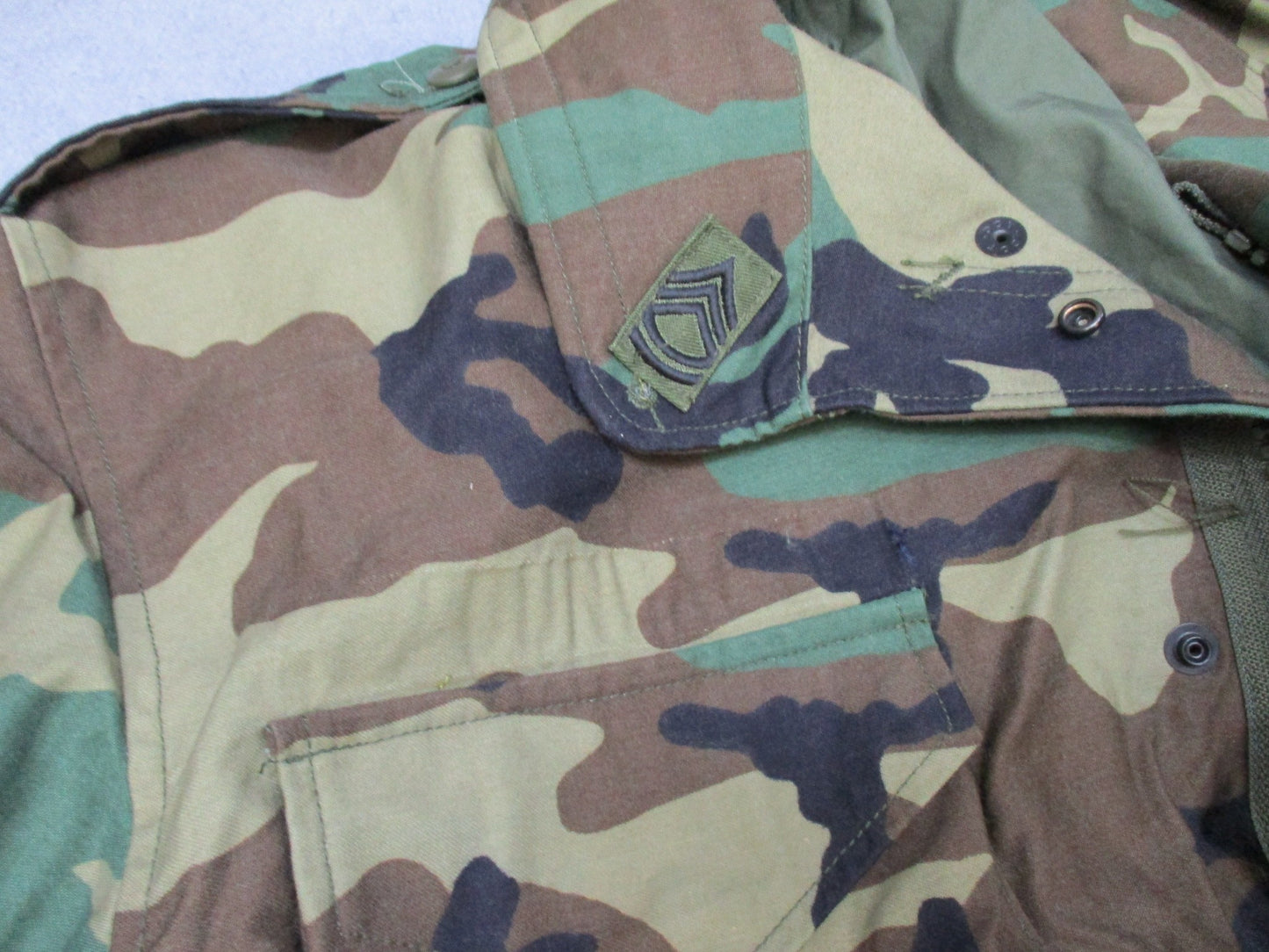 USGI M65 Field Jacket in woodland camouflage by Centex Military Gear, large regular cold weather coat with patches.
