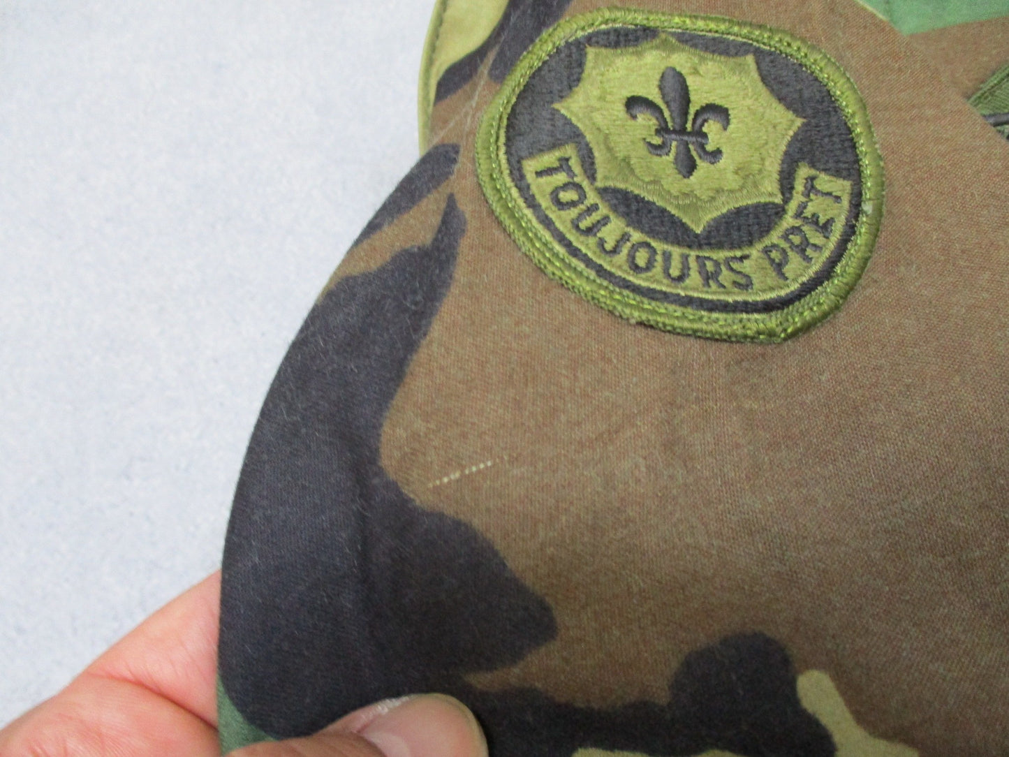 USGI M65 Field Jacket in Woodland camo, large regular size with patches, ideal for cold weather military-style wear by Centex Military Gear