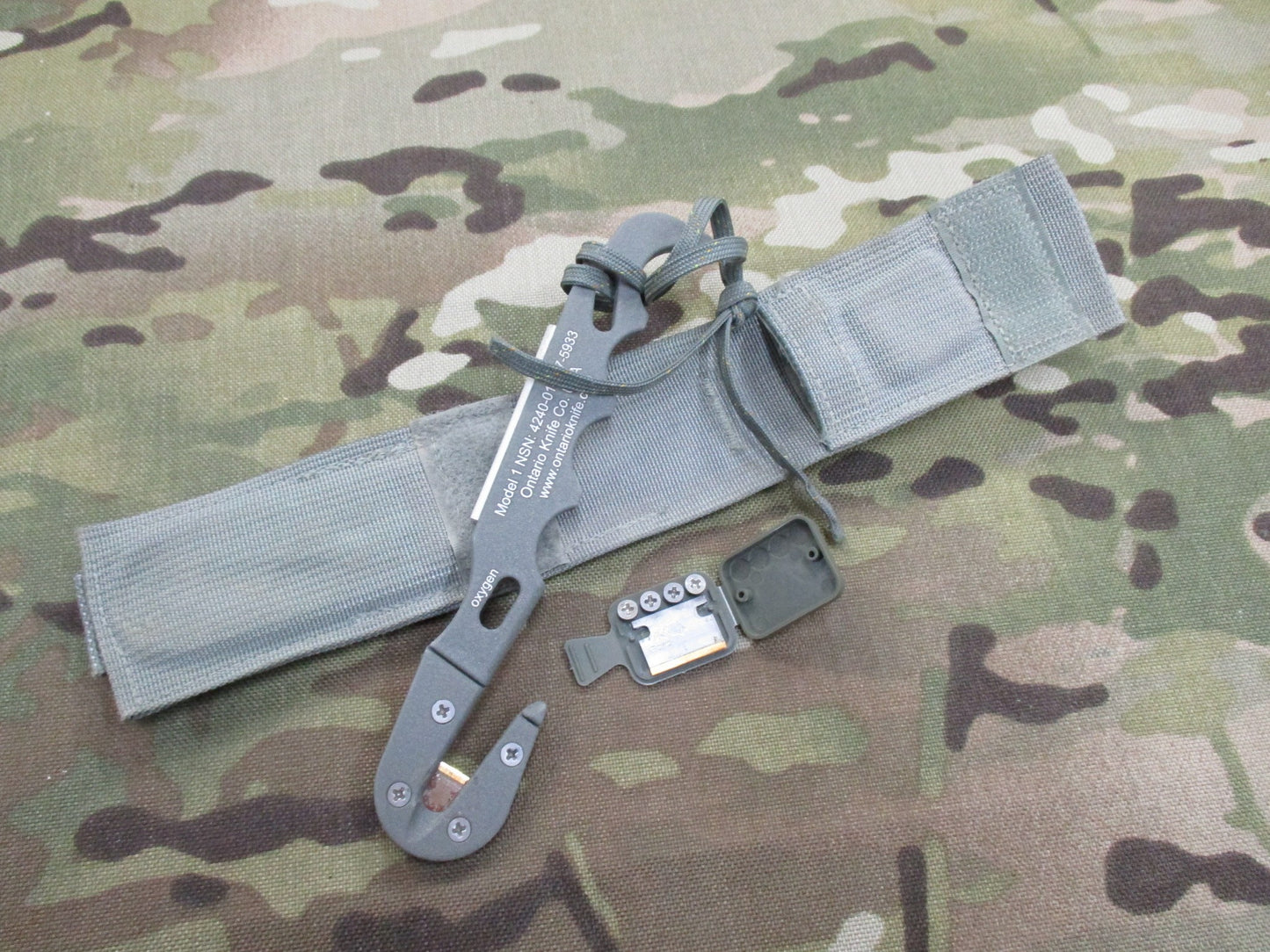 Used Ontario Knife strap and seat belt cutter with sheath, foliage parachute knife for survival and tactical use by Centex Military Gear