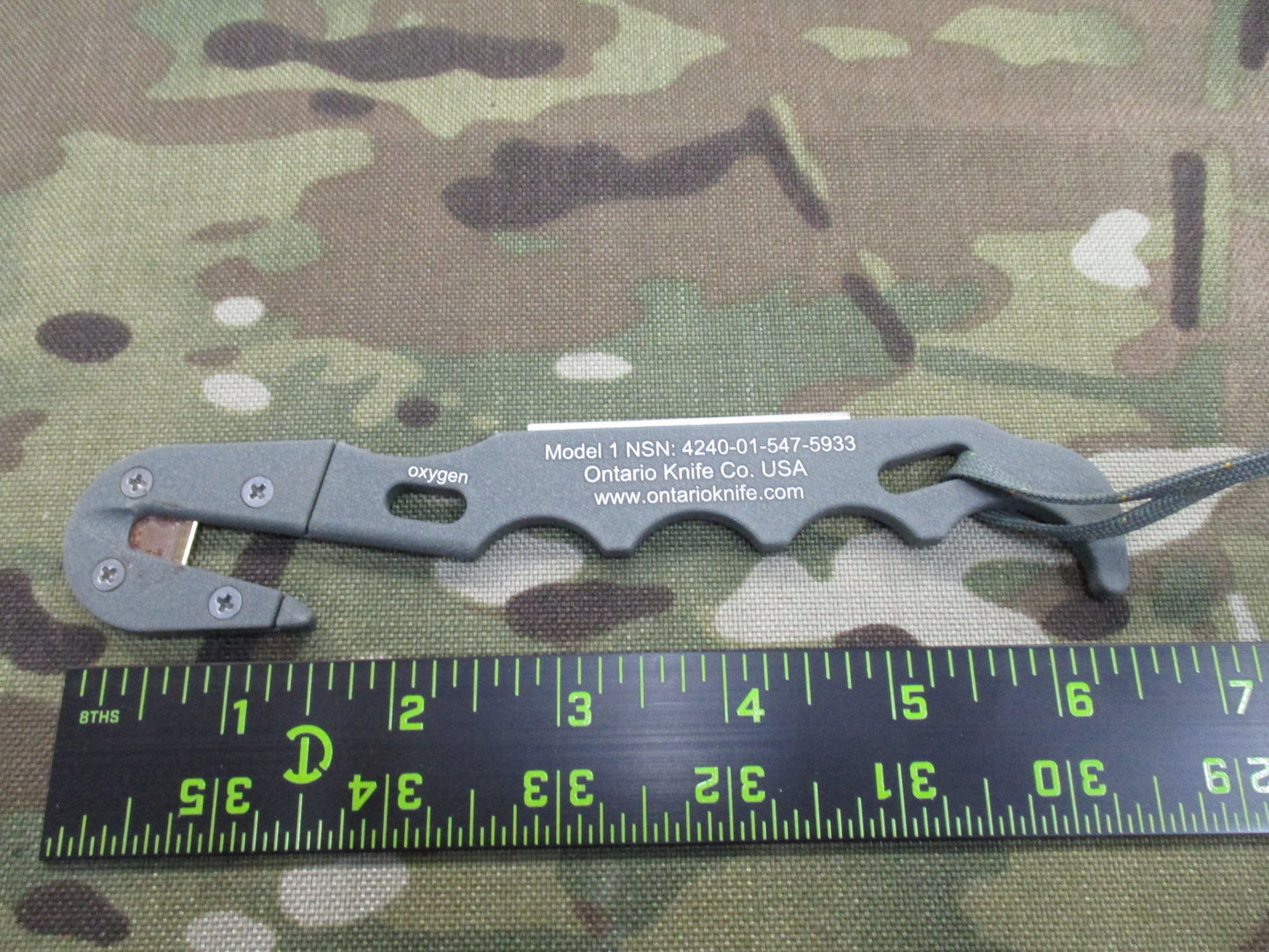 Ontario Knife Strap/Seat Belt Cutter with sheath, foliage parachute knife, designed for military and outdoor use, by Centex Military Gear.