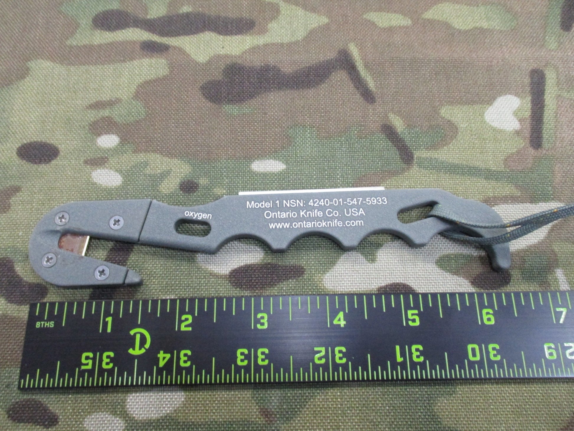Ontario Knife Strap/Seat Belt Cutter with sheath, foliage parachute knife, designed for military and outdoor use, by Centex Military Gear.