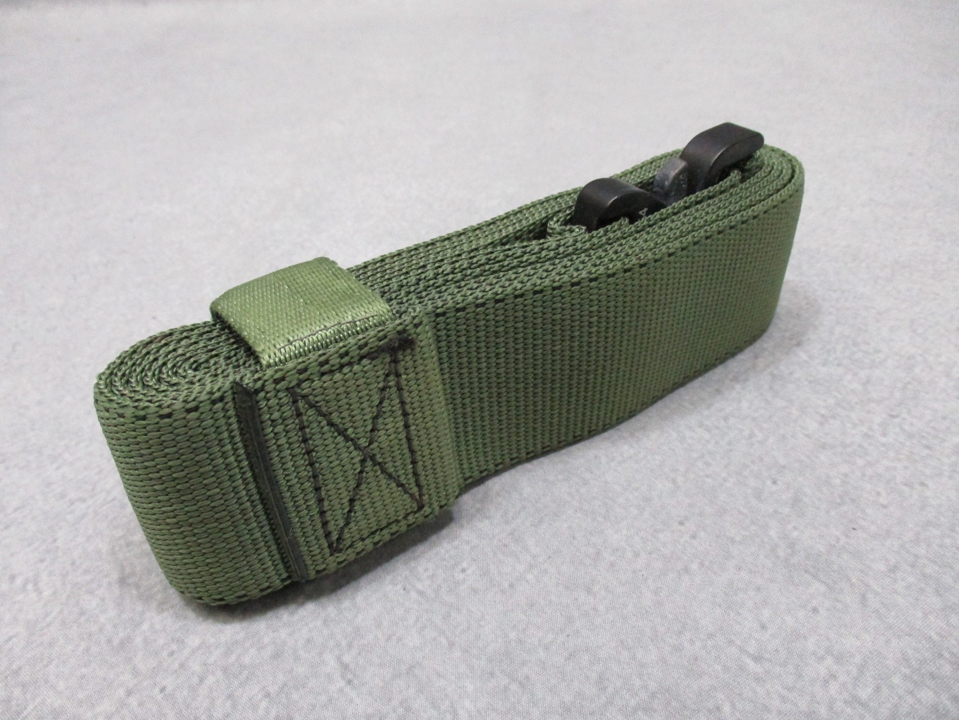 Heavy-duty US military stretcher strap with Cobra buckle for patient securing, made by Centex Military Gear, featuring durable stretch material.