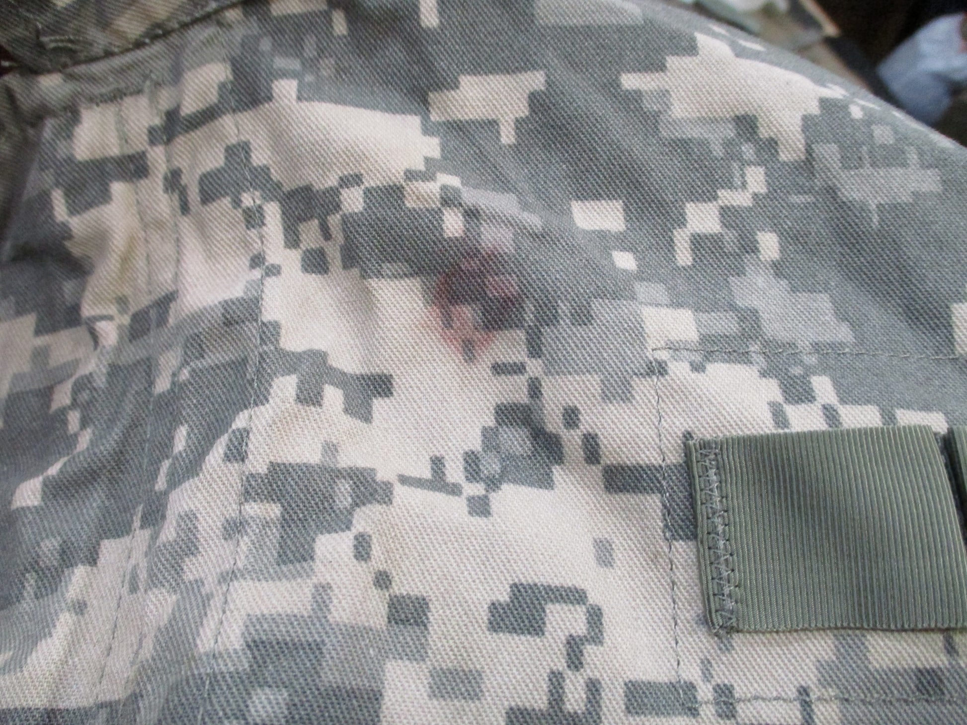 Used military army issue mechanic coveralls in UCP digital camouflage, size large, with front pockets and zip closure.