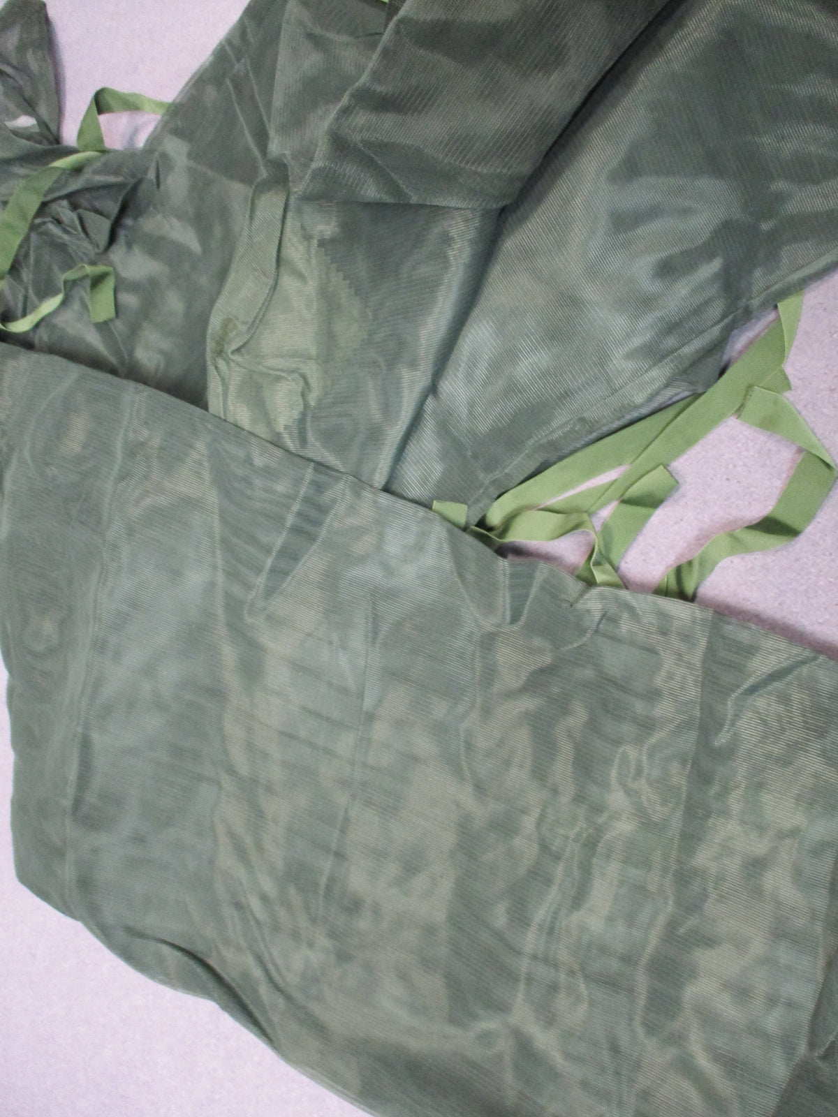 SEKRI USGI mosquito net insect protector in olive drab nylon, folded with storage pouch and military packaging