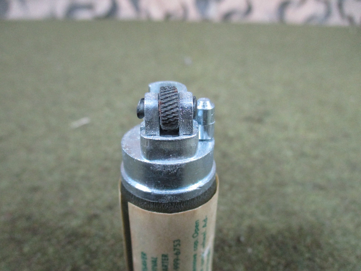1974 Lifesaver USGI aviator survival lighter firestarter, NOS empty display piece shown from the side